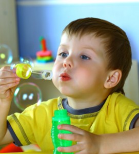 4 year old boy blowing bubbles